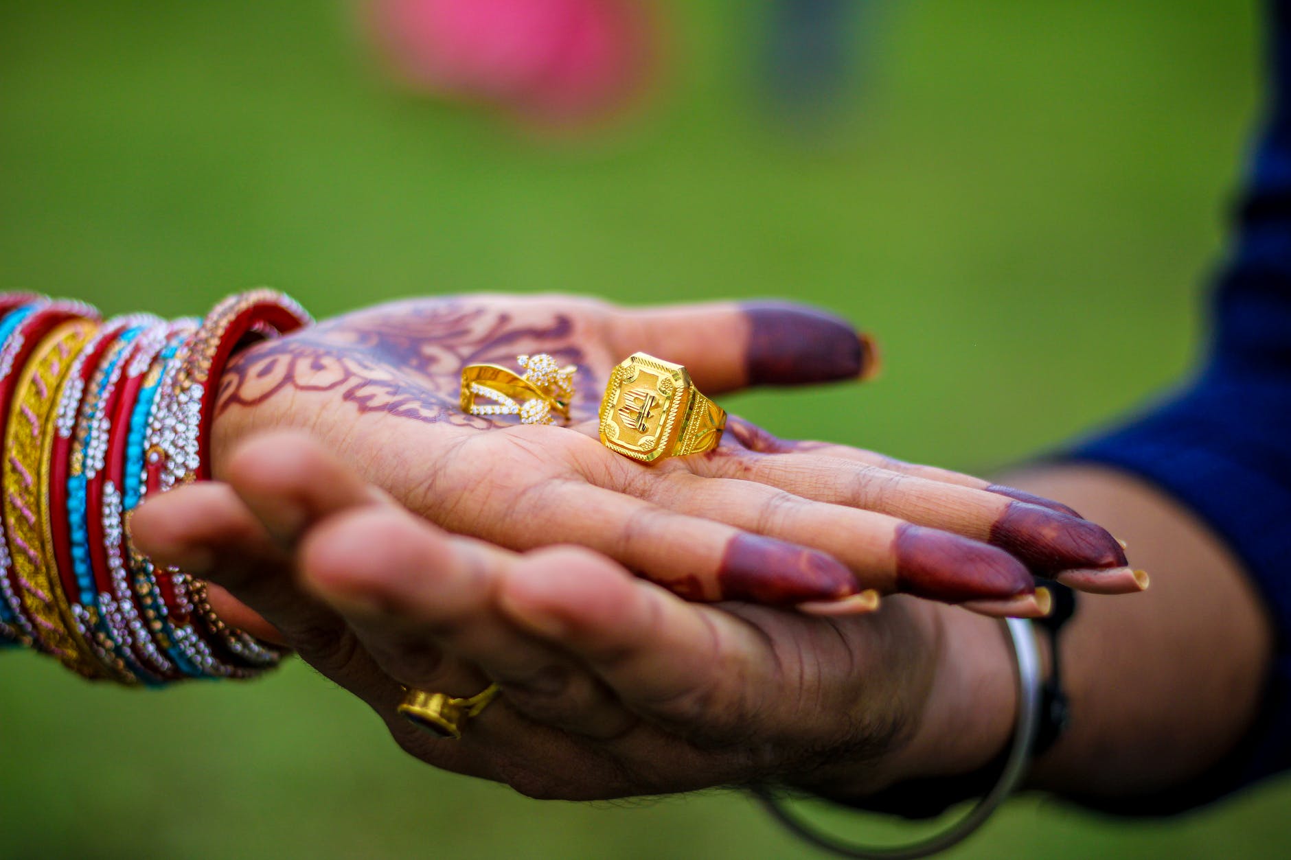 a person holding gold rings